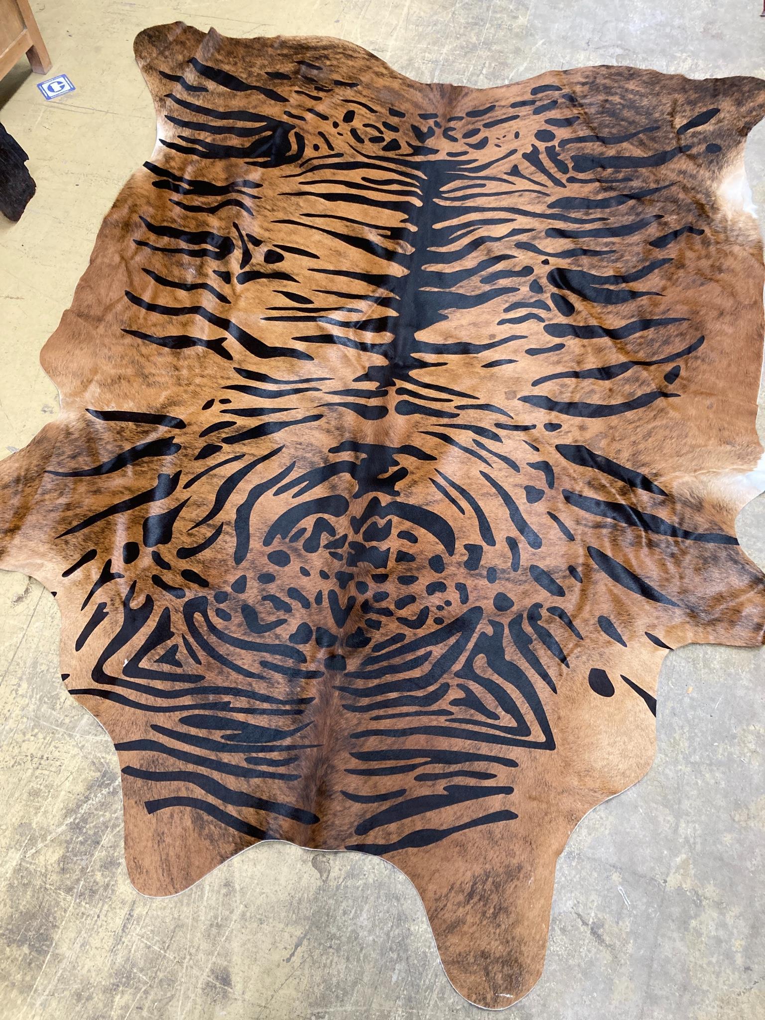 A tiger print South American cowhide rug, approx. 240 x 90cm
